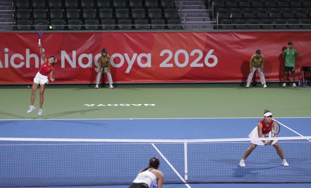 (261001) -- NAGOYA, Oct. 1, 2026 (Xinhua) -- Guo Hanyu/Zhang Shuai (L) of China compete during the women's doubles quarterfinals of tennis against Chan Hao-ching/Wu Fang-hsien of Chinese Taipei at the 20th Asian Games Aichi-Nagoya 2026 in Nagoya, Japan, Oct. 1, 2026. (Xinhua/Li Bo)