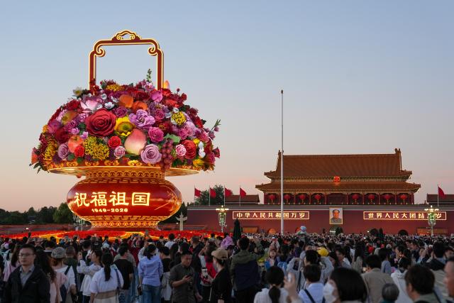(261001) -- BEIJING, Oct. 1, 2026 (Xinhua) -- People visit the Tian'anmen Square in Beijing, capital of China, Oct. 1, 2026. People celebrated the 77th anniversary of the founding of the People's Republic of China in various ways on Thursday. (Xinhua/Ju Huanzong)