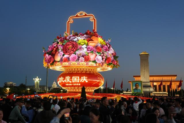 (261001) -- BEIJING, Oct. 1, 2026 (Xinhua) -- People visit the Tian'anmen Square in Beijing, capital of China, Oct. 1, 2026. People celebrated the 77th anniversary of the founding of the People's Republic of China in various ways on Thursday. (Xinhua/Ju Huanzong)