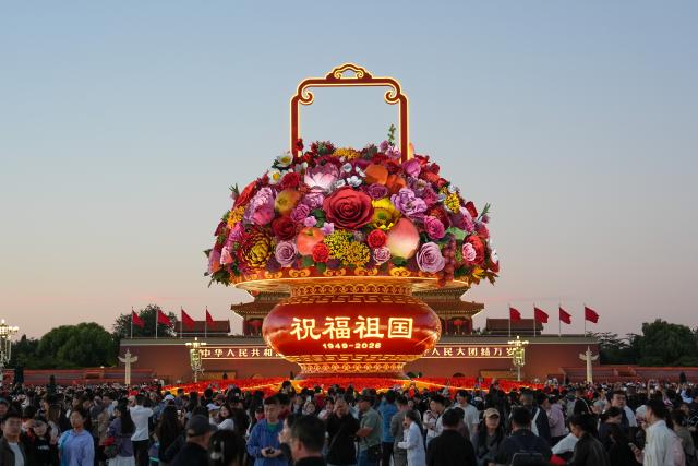 (261001) -- BEIJING, Oct. 1, 2026 (Xinhua) -- People visit the Tian'anmen Square in Beijing, capital of China, Oct. 1, 2026. People celebrated the 77th anniversary of the founding of the People's Republic of China in various ways on Thursday. (Xinhua/Ju Huanzong)
