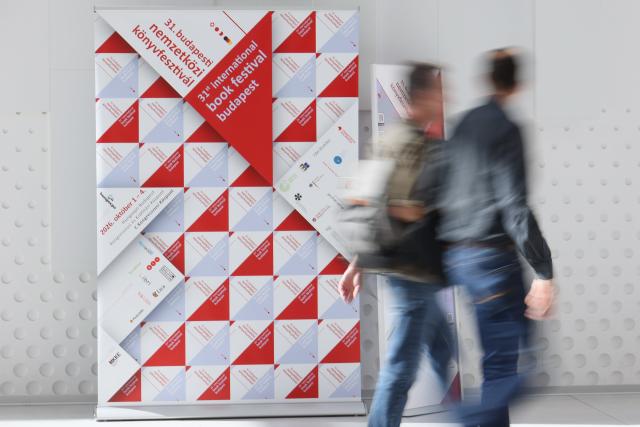(261001) -- BUDAPEST, Oct. 1, 2026 (Xinhua) -- People walk past a display board at the 31st Budapest International Book Festival in Budapest, Hungary, Oct. 1, 2026. The 31st Budapest International Book Festival opened in Budapest, Hungary, on Thursday and runs through Oct. 4. (Photo by Attila Volgyi/Xinhua)