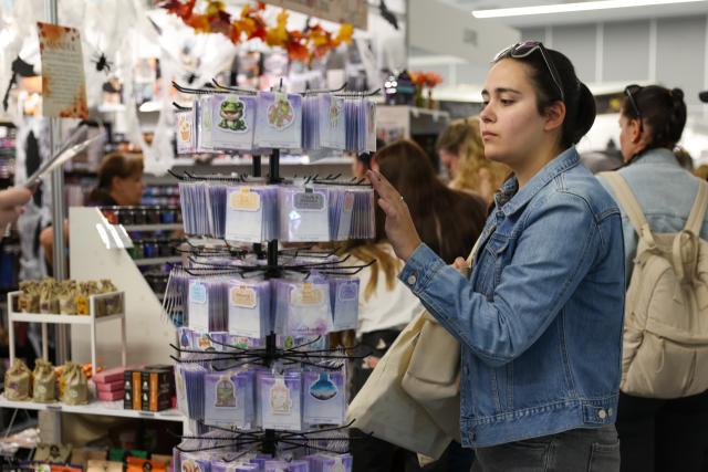 (261001) -- BUDAPEST, Oct. 1, 2026 (Xinhua) -- A woman selects products at the 31st Budapest International Book Festival in Budapest, Hungary, Oct. 1, 2026. The 31st Budapest International Book Festival opened in Budapest, Hungary, on Thursday and runs through Oct. 4. (Xinhua/Hu Zhixuan)