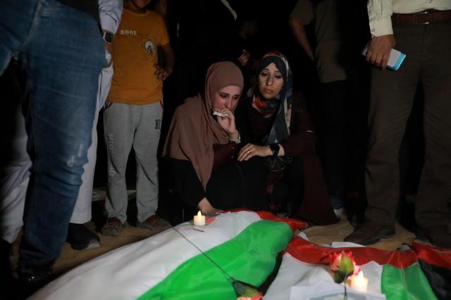 (261001) -- GAZA, Oct. 1, 2026 (Xinhua) -- Relatives mourn before a mass funeral of 105 victims whose remains were recovered nearly three years after a deadly Israeli strike, in Gaza City, Sept. 30, 2026. Dozens of Palestinians on Thursday held a mass funeral in Gaza City for 105 people killed in an Israeli bombardment of a residential block on Oct. 25, 2023. (Photo by Rizek Abdeljawad/Xinhua)