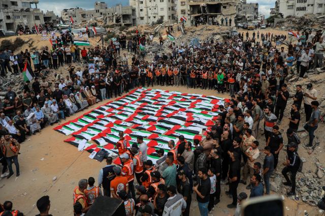 (261001) -- GAZA, Oct. 1, 2026 (Xinhua) -- People attend a mass funeral of 105 victims whose remains were recovered nearly three years after a deadly Israeli strike, in Gaza City, Oct. 1, 2026. Dozens of Palestinians on Thursday held a mass funeral in Gaza City for 105 people killed in an Israeli bombardment of a residential block on Oct. 25, 2023. (Photo by Rizek Abdeljawad/Xinhua)