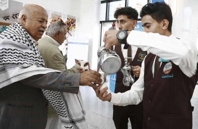 (261001) -- SANAA, Oct. 1, 2026 (Xinhua) -- Staff workers serve coffee for guests during an event to mark the International Coffee Day at Haraz Coffee Center in Sanaa, Yemen, Oct. 1, 2026. An event was held in Yemen's capital Sanaa on Thursday to mark International Coffee Day. (Photo by Mohammed Mohammed/Xinhua)
