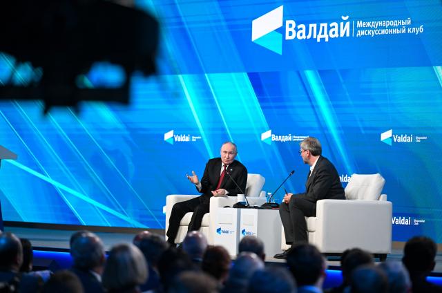 (261002) -- MOSCOW, Oct. 2, 2026 (Xinhua) -- Russian President Vladimir Putin (L) attends the plenary session of the 23rd annual meeting of the Valdai Discussion Club in Moscow, Russia, Oct. 1, 2026. Russian President Vladimir Putin on Thursday accused Western nations of erecting a new "iron curtain" in global relations and stressed that such isolationist policies are doomed to failure.
   During his speech at the plenary session of the 23rd annual meeting of the Valdai Discussion Club, Putin said that contrary to Western accusations, Russia has no intention of creating divides in the international community. (Xinhua/Feng Kaihua)