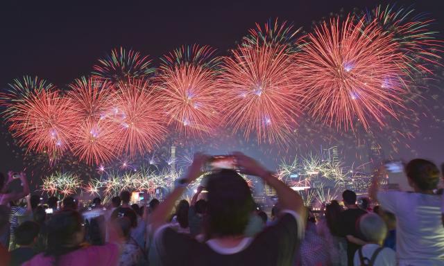 (261002) -- BEIJING, Oct. 2, 2026 (Xinhua) -- Tourists watch the firework show celebrating the 77th anniversary of the founding of the People's Republic of China in Hong Kong, south China, Oct. 1, 2026. (Xinhua/Chen Duo)