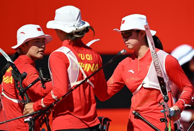 (261002) -- OKAZAKI, Oct. 2, 2026 (Xinhua) -- Huang Yuwei (L), Yu Qi (C), Zhu Jingyi of team China celebrate after the recurve women's team bronze medal match of archery against team Indonesia at the 20th Asian Games Aichi-Nagoya 2026 in Okazaki of Aichi Prefecture, Japan, Oct. 2, 2026. (Xinhua/Yu Yang)