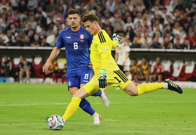 (261002) -- MUNICH, Oct. 2, 2026 (Xinhua) -- Jonas Urbig (R), goalkeeper of Germany and Luka Jovic of Serbia compete during the UEFA Nations League 2026/27 League A Group A2 match between Germany and Serbia in Munich, Germany, Oct. 1, 2026. (Photo by Philippe Ruiz/Xinhua)