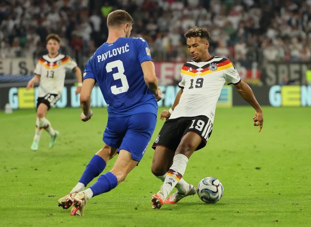 (261002) -- MUNICH, Oct. 2, 2026 (Xinhua) -- Bambase Conte (R) of Germany vies with Strahinja Pavlovic of Serbia during the UEFA Nations League 2026/27 League A Group A2 match between Germany and Serbia in Munich, Germany, Oct. 1, 2026. (Photo by Philippe Ruiz/Xinhua)
