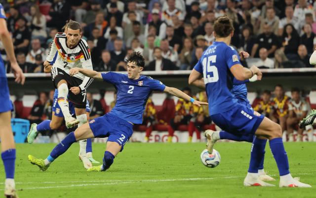 (261002) -- MUNICH, Oct. 2, 2026 (Xinhua) -- Said El Mala (L) of Germany vies with Kosta Nedeljkovic (C) of Serbia during the UEFA Nations League 2026/27 League A Group A2 match between Germany and Serbia in Munich, Germany, Oct. 1, 2026. (Photo by Philippe Ruiz/Xinhua)