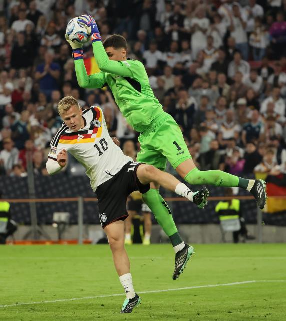 (261002) -- MUNICH, Oct. 2, 2026 (Xinhua) -- Jonathan Burkardt (L) of Germany and Djordje Petrovic, goalkeeper of Serbia compete during the UEFA Nations League 2026/27 League A Group A2 match between Germany and Serbia in Munich, Germany, Oct. 1, 2026. (Photo by Philippe Ruiz/Xinhua)