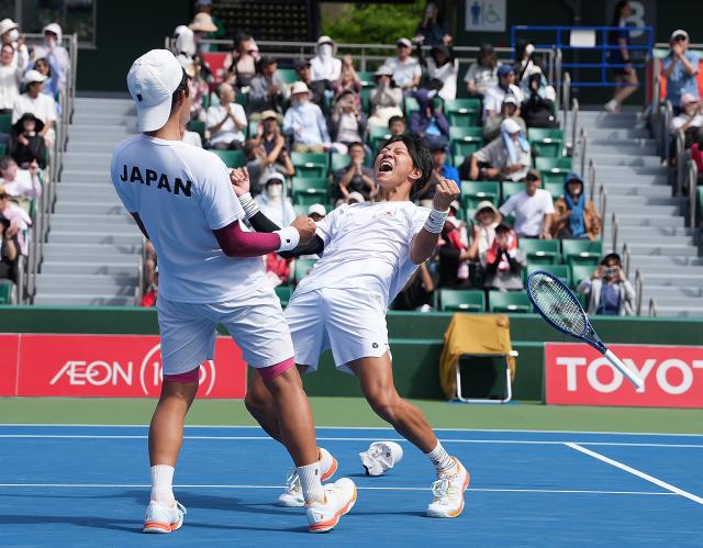 (261002) -- NAGOYA, Oct. 2, 2026 (Xinhua) -- Kusuhara Yusuke/Nakagawa Shunsuke (R) of Japan celebrate after winning the men's doubles Gold Medal Match of tennis between Kusuhara Yusuke/Nakagawa Shunsuke of Japan and Nam Jisung/Park Uisung of South Korea at the 20th Asian Games Aichi-Nagoya 2026 in Nagoya, Japan, Oct. 2, 2026. (Xinhua/Li Bo)