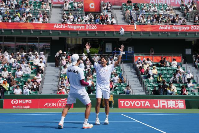 (261002) -- NAGOYA, Oct. 2, 2026 (Xinhua) -- Kusuhara Yusuke/Nakagawa Shunsuke (R) of Japan celebrate after winning the men's doubles Gold Medal Match of tennis between Kusuhara Yusuke/Nakagawa Shunsuke of Japan and Nam Jisung/Park Uisung of South Korea at the 20th Asian Games Aichi-Nagoya 2026 in Nagoya, Japan, Oct. 2, 2026. (Xinhua/Li Bo)