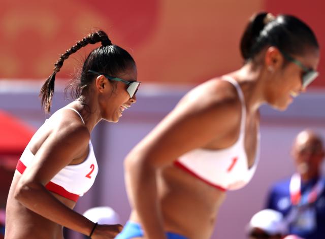 (261002) -- HEKINAN, Oct. 2, 2026 (Xinhua) -- Khylem Harl Progella/Sofiah Shanine Pagara (L) of the Philippines react during the Women's Beach Volleyball Bronze Medal Match between Cao Shuting/Dong Jie of China and Khylem Harl Progella/Sofiah Shanine Pagara of the Philippines at the 20th Asian Games Aichi-Nagoya 2026 in Hekinan of Aichi Prefecture, Japan, Oct. 2, 2026. (Xinhua/Luo Yuan)
