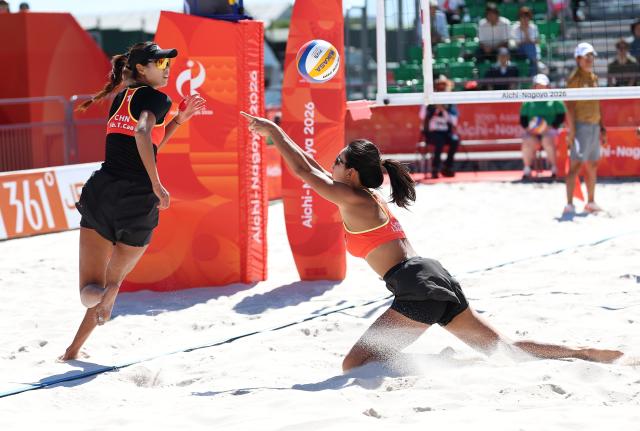 (261002) -- HEKINAN, Oct. 2, 2026 (Xinhua) -- Cao Shuting (L)/Dong Jie of China compete during the Women's Beach Volleyball Bronze Medal Match between Cao Shuting/Dong Jie of China and Khylem Harl Progella/Sofiah Shanine Pagara of the Philippines at the 20th Asian Games Aichi-Nagoya 2026 in Hekinan of Aichi Prefecture, Japan, Oct. 2, 2026. (Xinhua/Luo Yuan)
