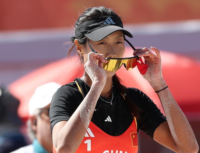 (261002) -- HEKINAN, Oct. 2, 2026 (Xinhua) -- Cao Shuting of China reacts during the Women's Beach Volleyball Bronze Medal Match between Cao Shuting/Dong Jie of China and Khylem Harl Progella/Sofiah Shanine Pagara of the Philippines at the 20th Asian Games Aichi-Nagoya 2026 in Hekinan of Aichi Prefecture, Japan, Oct. 2, 2026. (Xinhua/Luo Yuan)