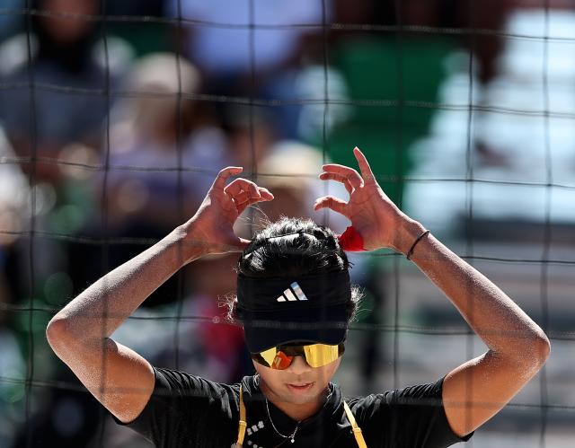 (261002) -- HEKINAN, Oct. 2, 2026 (Xinhua) -- Cao Shuting of China reacts during the Women's Beach Volleyball Bronze Medal Match between Cao Shuting/Dong Jie of China and Khylem Harl Progella/Sofiah Shanine Pagara of the Philippines at the 20th Asian Games Aichi-Nagoya 2026 in Hekinan of Aichi Prefecture, Japan, Oct. 2, 2026. (Xinhua/Luo Yuan)