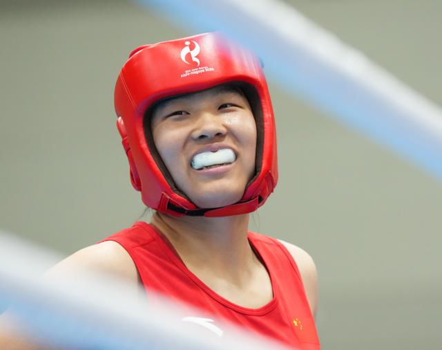 (261002) -- NISHIO, Oct. 2, 2026 (Xinhua) -- Bao Ziyi of China reacts ahead of the women's 75kg final bout of boxing against Lovlina Borgohain of India at the 20th Asian Games Aichi-Nagoya 2026 in Nishio of Aichi Prefecture, Japan, Oct. 2, 2026. (Xinhua/Chen Zeguo)