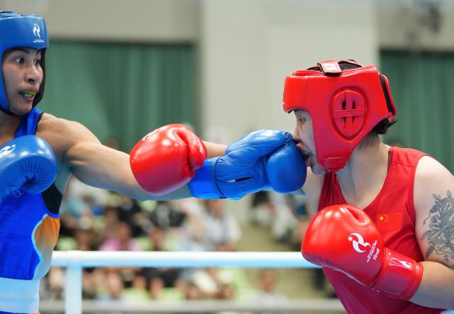 (261002) -- NISHIO, Oct. 2, 2026 (Xinhua) -- Bao Ziyi (R) of China competes with Lovlina Borgohain of India during their women's 75kg final bout of boxing at the 20th Asian Games Aichi-Nagoya 2026 in Nishio of Aichi Prefecture, Japan, Oct. 2, 2026. (Xinhua/Chen Zeguo)