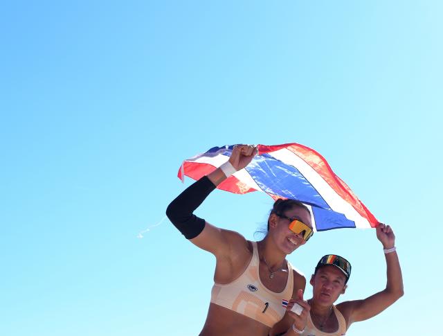 (261002) -- HEKINAN, Oct. 2, 2026 (Xinhua) -- Taravadee Naraphornrapat (R)/Worapeerachayakorn Kongphopsarutawadee of Thailand celebrate after winning the Women's Beach Volleyball Gold Medal Match between Xia Xinyi/Yan Xu of China and Taravadee Naraphornrapat/Worapeerachayakorn Kongphopsarutawadee of Thailand at the 20th Asian Games Aichi-Nagoya 2026 in Hekinan of Aichi Prefecture, Japan, Oct. 2, 2026. (Xinhua/Luo Yuan)