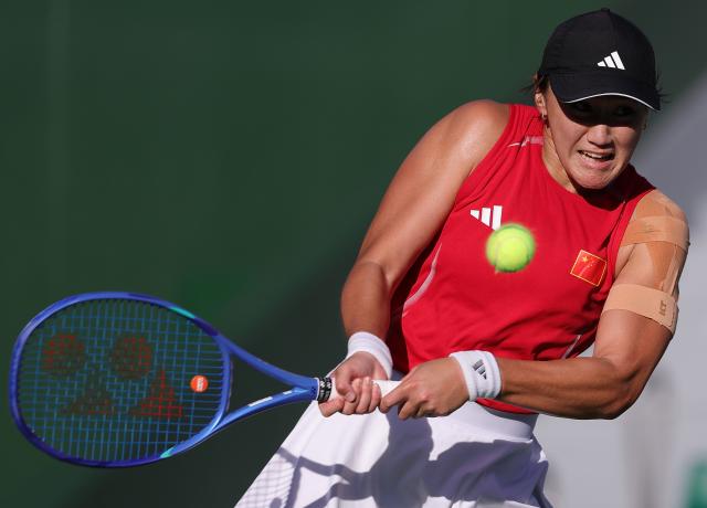 (261002) -- NAGOYA, Oct. 2, 2026 (Xinhua) -- Wang Xiyu hits a return during the women's singles Gold Medal Match of tennis between Wang Xiyu of China and Zhang Shuai of China at the 20th Asian Games Aichi-Nagoya 2026 in Nagoya, Japan, Oct. 2, 2026. (Xinhua/Li Bo)