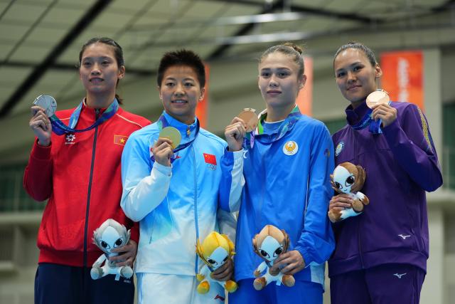 (261002) -- NISHIO, Oct. 2, 2026 (Xinhua) -- Gold medalist Wu Yu (2nd L) of China, silver medalist Nguyen Thi Tam (1st L) of Vietnam, bronze medalists Feruza Kazakova (2nd R) of Uzbekistan and Alua Balkibekova of Kazakhstan pose for photos during the victory ceremony for the women's 51kg of boxing at the 20th Asian Games Aichi-Nagoya 2026 in Nishio of Aichi Prefecture, Japan, Oct. 2, 2026. (Xinhua/Chen Zeguo)