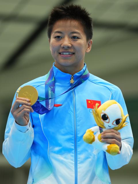 (261002) -- NISHIO, Oct. 2, 2026 (Xinhua) -- Gold medalist Wu Yu of China poses for photos during the victory ceremony for the women's 51kg of boxing at the 20th Asian Games Aichi-Nagoya 2026 in Nishio of Aichi Prefecture, Japan, Oct. 2, 2026. (Xinhua/Chen Zeguo)