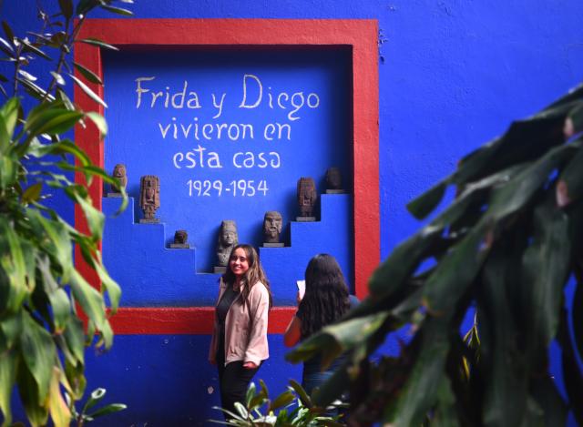 (261002) -- MEXICO CITY, Oct. 2, 2026 (Xinhua) -- A woman poses for photos at the Casa Azul Museum in Mexico City, Mexico, Oct. 1, 2026. Casa Azul Museum is the former residence of Mexican painter Frida Kahlo. (Xinhua/Zhang Lei)