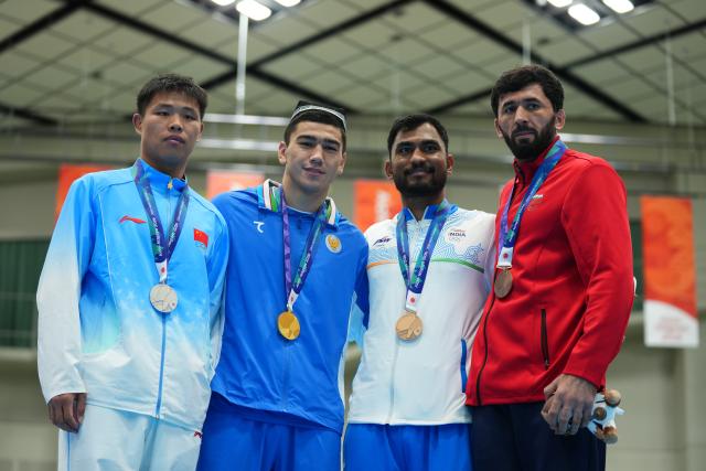 (261002) -- NISHIO, Oct. 2, 2026 (Xinhua) -- Turabek Khabibullaev (2nd L) of Uzbekistan, silver medalist Han Xuezhen (1st L) of China, bronze medalists Kapil Pokhariya (2nd R) of India and Parviz Karimov of Tajikistan pose during the awarding ceremony for the men's 90kg of boxing at the 20th Asian Games Aichi-Nagoya 2026 in Nishio of Aichi Prefecture, Japan, Oct. 2, 2026. (Xinhua/Chen Zeguo)