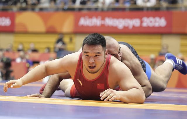 (261002) -- NAGOYA, Oct. 2, 2026 (Xinhua) -- Buheeerdun (front) of China competes with Amir Hossein Zare of Iran during the men's freestyle 125kg final match of Wrestling at the 20th Asian Games Aichi-Nagoya 2026 in Nagoya, Japan, Oct. 2, 2026. (Xinhua/Long Lei)