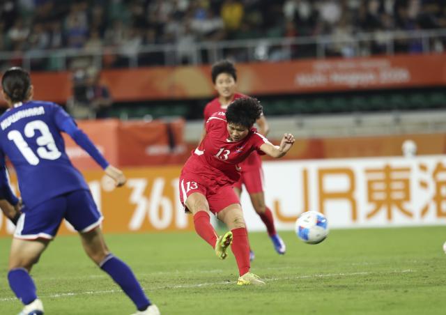 (261002) -- FUKUROI, Oct. 2, 2026 (Xinhua) -- Jon Ryong Jong of DPRK shoots to scroe during the women's final match of football between Japan and the Democratic People's Republic of Korea (DPRK) at 20th Asian Games Aichi-Nagoya 2026 in Fukuroi of Shizuoka Prefecture, Japan, Oct. 2, 2026. (Xinhua/Jia Haocheng)