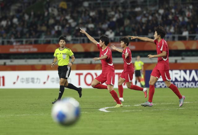 (261002) -- FUKUROI, Oct. 2, 2026 (Xinhua) -- Players of DPRK gesture for a VAR review during the women's final match of football between Japan and the Democratic People's Republic of Korea (DPRK) at 20th Asian Games Aichi-Nagoya 2026 in Fukuroi of Shizuoka Prefecture, Japan, Oct. 2, 2026. (Xinhua/Jia Haocheng)