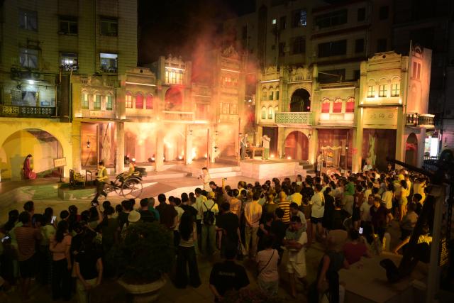 (261002) -- BEIJING, Oct. 2, 2026 (Xinhua) -- People watch a live-action drama at a scenic spot in Beihai, south China's Guangxi Zhuang Autonomous Region, Oct. 1, 2026. During the National Day holiday, various cultural and tourism events are held across the country to attract visitors. (Photo by Li Junguang/Xinhua)