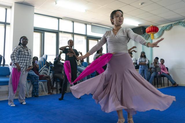 (261002) -- NAIROBI, Oct. 2, 2026 (Xinhua) -- Mu Yuying (front), a Chinese teacher at the Confucius Institute of Kenyatta University, teaches local students Chinese dance in Nairobi, Kenya, Oct. 1, 2026. The Confucius Institute at Kenyatta University, located in Nairobi, Kenya, is jointly established by Shandong Normal University and Kenyatta University, serving as a platform for local students to learn about China and experience Chinese culture. Besides formal classes, clubs of dancing, martial arts, calligraphy and painting, cuisine, and recitation are also popular among local students. (Xinhua/Xie Jianfei)
