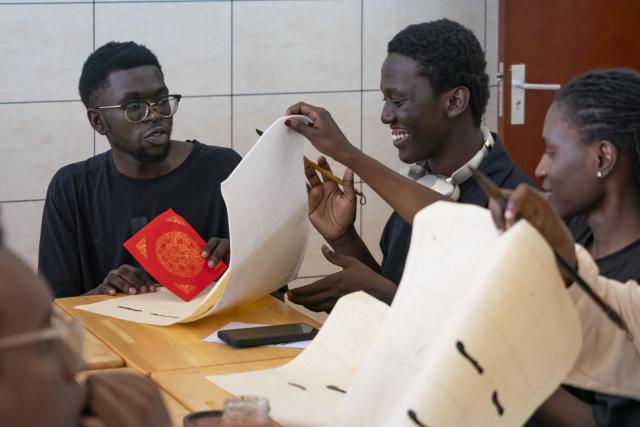 (261002) -- NAIROBI, Oct. 2, 2026 (Xinhua) -- Local students attend a calligraphy class at the Confucius Institute of Kenyatta University in Nairobi, Kenya, Oct. 1, 2026. The Confucius Institute at Kenyatta University, located in Nairobi, Kenya, is jointly established by Shandong Normal University and Kenyatta University, serving as a platform for local students to learn about China and experience Chinese culture. Besides formal classes, clubs of dancing, martial arts, calligraphy and painting, cuisine, and recitation are also popular among local students. (Xinhua/Xie Jianfei)