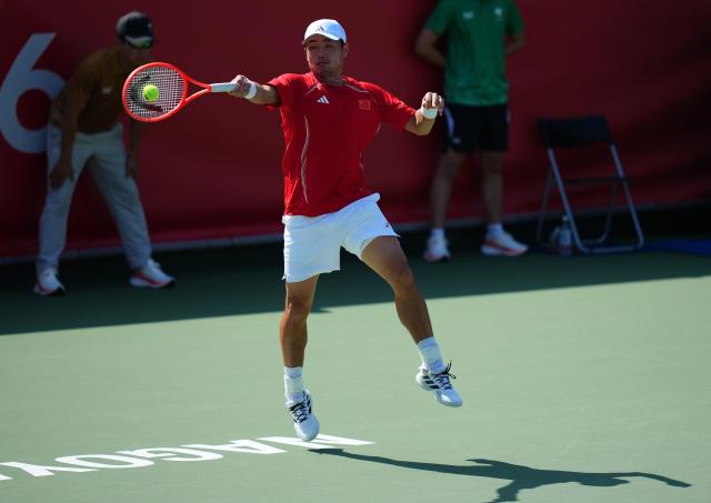 (261003) -- NAGOYA, Oct. 3, 2026 (Xinhua) -- Wu Yibing of China hits a return during the Men's Singles Gold Medal Match of Tennis between Wu Yibing of China and Wong Coleman of Hong Kong, China at the 20th Asian Games Aichi-Nagoya 2026 in Nagoya, Japan, Oct. 3, 2026. (Xinhua/Chen Zeguo)