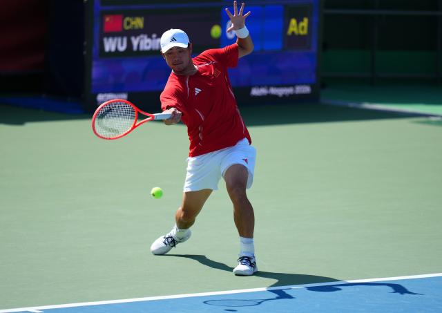 (261003) -- NAGOYA, Oct. 3, 2026 (Xinhua) -- Wu Yibing of China hits a return during the Men's Singles Gold Medal Match of Tennis between Wu Yibing of China and Wong Coleman of Hong Kong, China at the 20th Asian Games Aichi-Nagoya 2026 in Nagoya, Japan, Oct. 3, 2026. (Xinhua/Chen Zeguo)