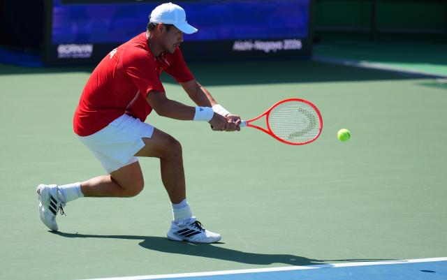 (261003) -- NAGOYA, Oct. 3, 2026 (Xinhua) -- Wu Yibing of China hits a return during the Men's Singles Gold Medal Match of Tennis between Wu Yibing of China and Wong Coleman of Hong Kong, China at the 20th Asian Games Aichi-Nagoya 2026 in Nagoya, Japan, Oct. 3, 2026. (Xinhua/Chen Zeguo)