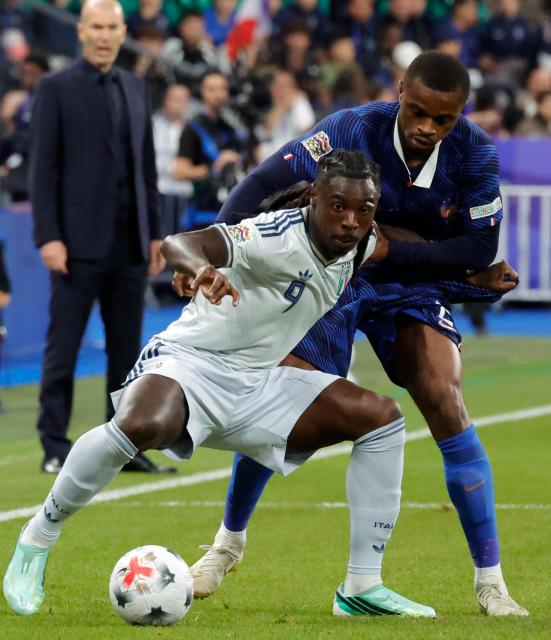 (261003) -- PARIS, Oct. 3, 2026 (Xinhua) -- France's Pierre Kalulu (R) vies with Italy's Moise Kean during the UEFA Nations League 2026/27 League A Group A1 match between France and Italy in Paris, France, Oct. 2, 2026. (Photo by Henri Szwarc/Xinhua)