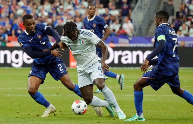 (261003) -- PARIS, Oct. 3, 2026 (Xinhua) -- France's Pierre Kalulu (L) and Ousmane Dembele (R) vie with Italy's Moise Kean during the UEFA Nations League 2026/27 League A Group A1 match between France and Italy in Paris, France, Oct. 2, 2026. (Photo by Henri Szwarc/Xinhua)