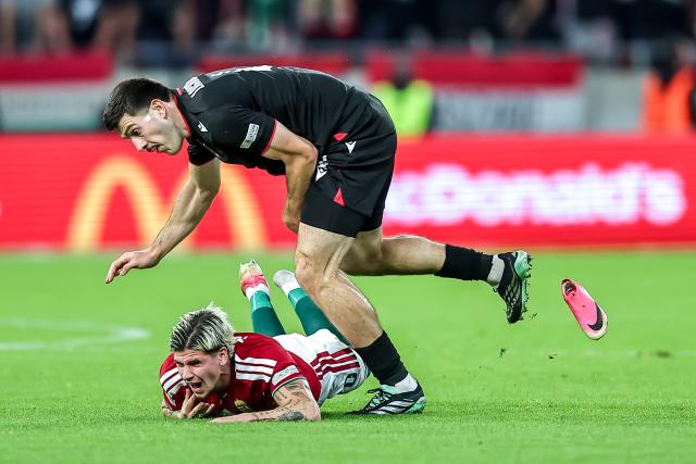 (261003) -- BUDAPEST, Oct. 3, 2026 (Xinhua) -- Milan Toth (bottom) of Hungary vies with Luka Lochoshvili of Georgia during the UEFA Nations League 2026/27 League B Group B2 match between Hungary and Georgia in Budapest, Hungary, Oct. 2, 2026. (Photo by David Balogh/Xinhua)