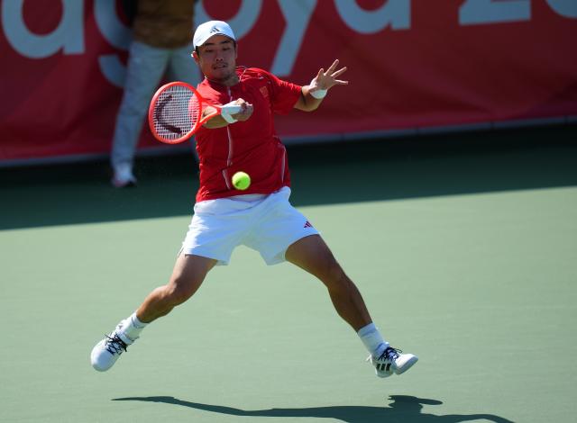 (261003) -- NAGOYA, Oct. 3, 2026 (Xinhua) -- Wu Yibing of China hits a return during the Men's Singles Gold Medal Match of Tennis between Wu Yibing of China and Wong Coleman of Hong Kong, China at the 20th Asian Games Aichi-Nagoya 2026 in Nagoya, Japan, Oct. 3, 2026. (Xinhua/Chen Zeguo)