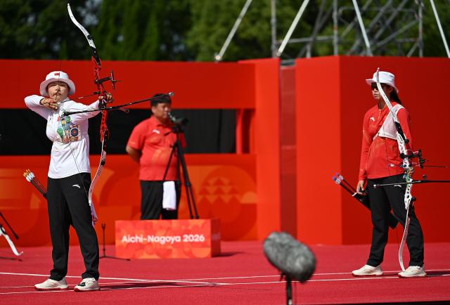 (261003) -- OKAZAKI, Oct. 3, 2026 (Xinhua) -- Huang Yuwei (L) of China competes against Zhu Jingyi of China during their Recurve Women's Individual Bronze Medal Match of Archery at the 20th Asian Games Aichi-Nagoya 2026 in Okazaki of Aichi Prefecture, Japan, Oct. 3, 2026. (Xinhua/Yu Yang)