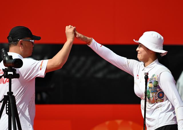 (261003) -- OKAZAKI, Oct. 3, 2026 (Xinhua) -- Huang Yuwei (R) of China celebrates after winning the Recurve Women's Individual Bronze Medal Match of Archery against Zhu Jingyi of China at the 20th Asian Games Aichi-Nagoya 2026 in Okazaki of Aichi Prefecture, Japan, Oct. 3, 2026. (Xinhua/Yu Yang)