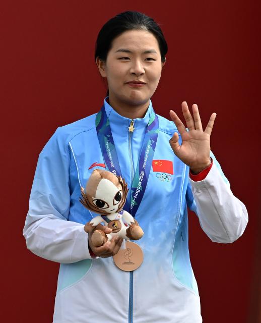 (261003) -- OKAZAKI, Oct. 3, 2026 (Xinhua) -- Bronze medalist Huang Yuwei of China reacts during the victory ceremony for the Recurve Women's Individual of Archery at the 20th Asian Games Aichi-Nagoya 2026 in Okazaki of Aichi Prefecture, Japan, Oct. 3, 2026. (Xinhua/Yu Yang)