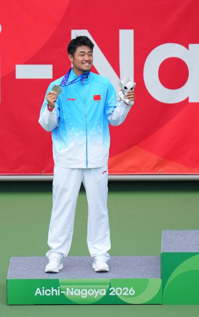 (261003) -- NAGOYA, Oct. 3, 2026 (Xinhua) -- Silver medalist Wu Yibing of China poses during the victory ceremony for the Men's Singles of Tennis at the 20th Asian Games Aichi-Nagoya 2026 in Nagoya, Japan, Oct. 3, 2026. (Xinhua/Chen Zeguo)