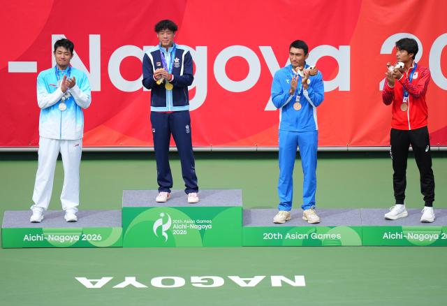 (261003) -- NAGOYA, Oct. 3, 2026 (Xinhua) -- Gold medalist Wong Coleman (2nd L) of China's Hong Kong, silver medalist Wu Yibing (1st L) of China and bronze medalists Khumoyun Sultanov (2nd R) of Uzbekistan and Matsuoka Hayato of Japan pose during the victory ceremony for the Men's Singles of Tennis at the 20th Asian Games Aichi-Nagoya 2026 in Nagoya, Japan, Oct. 3, 2026. (Xinhua/Chen Zeguo)