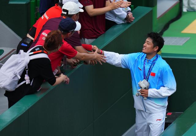 (261003) -- NAGOYA, Oct. 3, 2026 (Xinhua) -- Silver medalist Wu Yibing (R) of China greets the spectators after the victory ceremony for the Men's Singles of Tennis at the 20th Asian Games Aichi-Nagoya 2026 in Nagoya, Japan, Oct. 3, 2026. (Xinhua/Chen Zeguo)