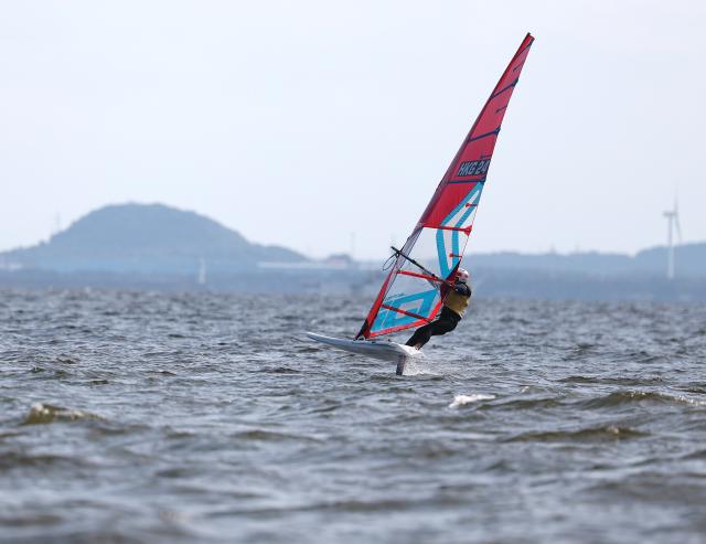 (261003) -- GAMAGORI, Oct. 3, 2026 (Xinhua) -- Cheung Tsz Yuet of China's Hong Kong competes during the Girls' Windsurfing Opening Series Race of Sailing at the 20th Asian Games Aichi-Nagoya 2026 in Gamagori of Aichi Prefecture, Japan, Oct. 3, 2026. (Xinhua/Deng Hua)